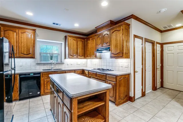 a kitchen with stainless steel appliances granite countertop a sink and cabinets