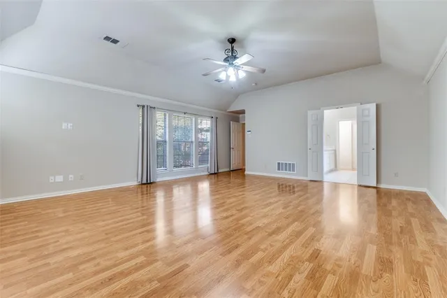 a view of a room with wooden floor and chandelier