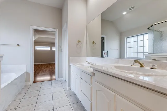 a bathroom with a bathtub and a sink