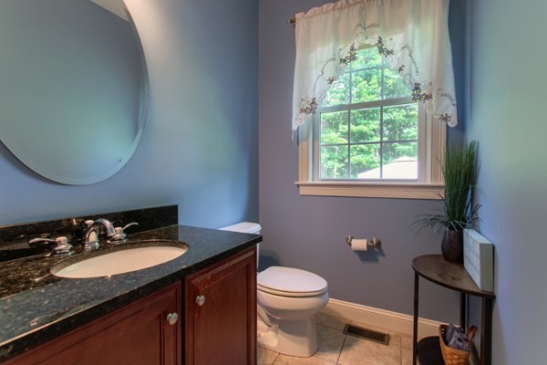 2 Otters Way Sterling, MA 01564 - Photo 11 of 30 a bathroom with a granite countertop sink vanity mirror and toilet