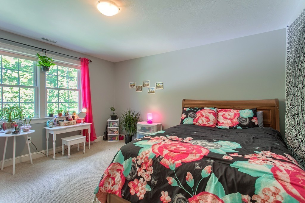 2 Otters Way Sterling, MA 01564 - Photo 14 of 30 a bedroom with a bed and a chandelier