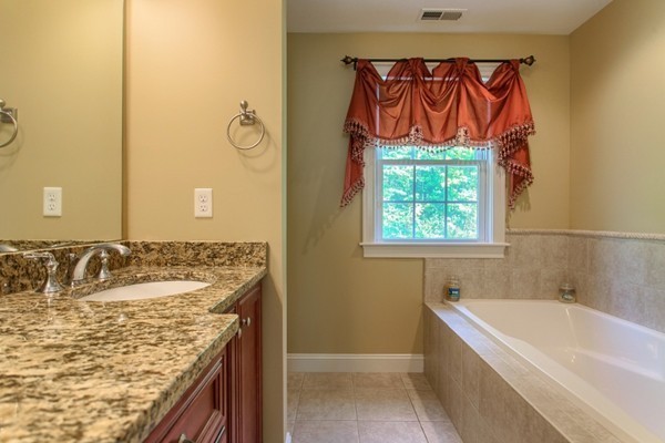 2 Otters Way Sterling, MA 01564 - Photo 15 of 30 a bathroom with a granite countertop sink and a bathtub