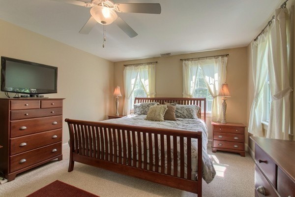 2 Otters Way Sterling, MA 01564 - Photo 19 of 30 a bedroom with a bed and a flat tv screen on dresser