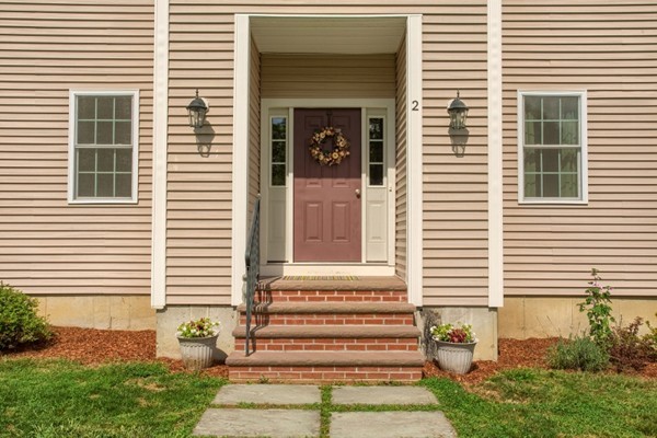 2 Otters Way Sterling, MA 01564 - Photo 2 of 30 a front view of a house with a yard and garage