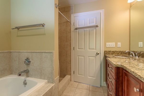 2 Otters Way Sterling, MA 01564 - Photo 22 of 30 a bathroom with a granite countertop sink and a bathtub