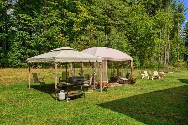 2 Otters Way Sterling, MA 01564 - Photo 24 of 30 a backyard of a house with table and chairs