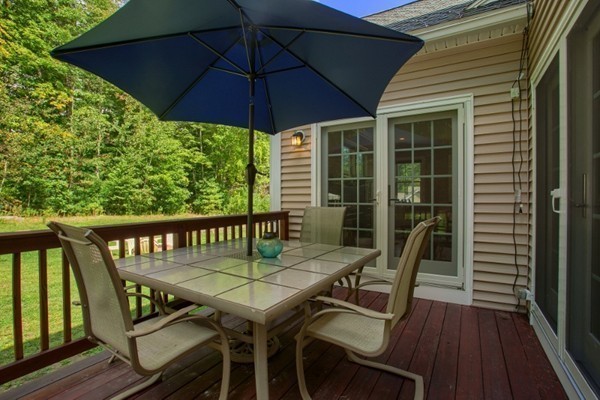 2 Otters Way Sterling, MA 01564 - Photo 26 of 30 a view of a balcony with table and chairs under an umbrella