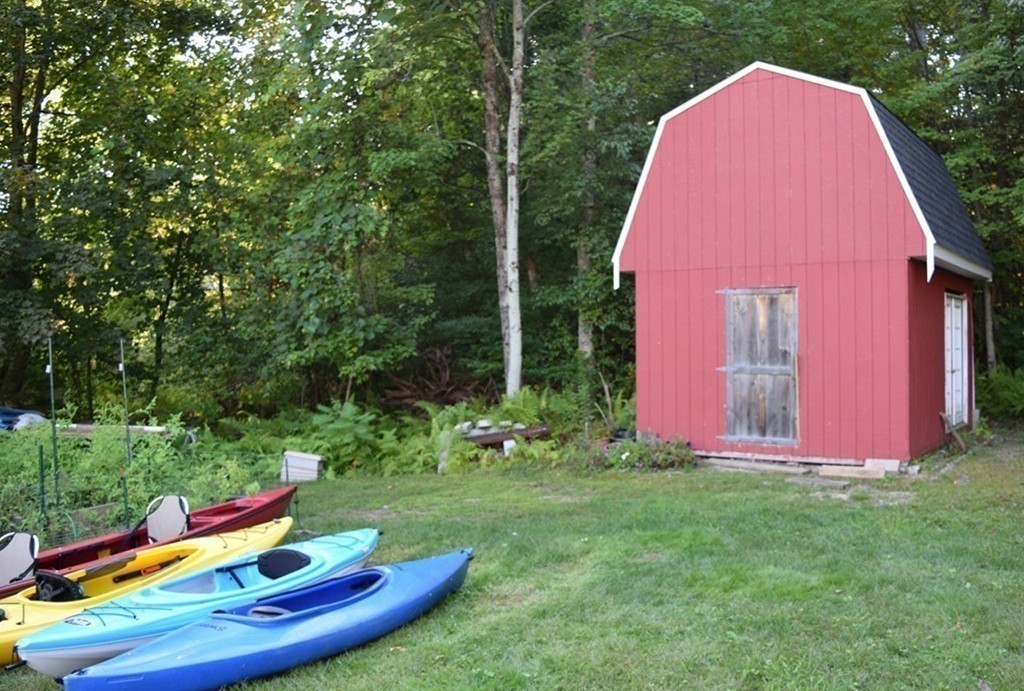 2 Otters Way Sterling, MA 01564 - Photo 28 of 30 a view of a backyard with plants and a fountain