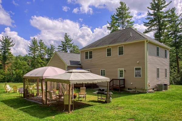 2 Otters Way Sterling, MA 01564 - Photo 4 of 30 a backyard of a house with table and chairs
