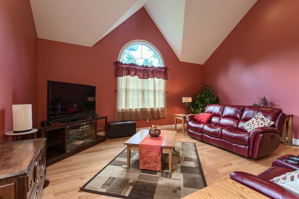 2 Otters Way Sterling, MA 01564 - Photo 5 of 30 a living room with furniture a flat screen tv and a floor to ceiling window