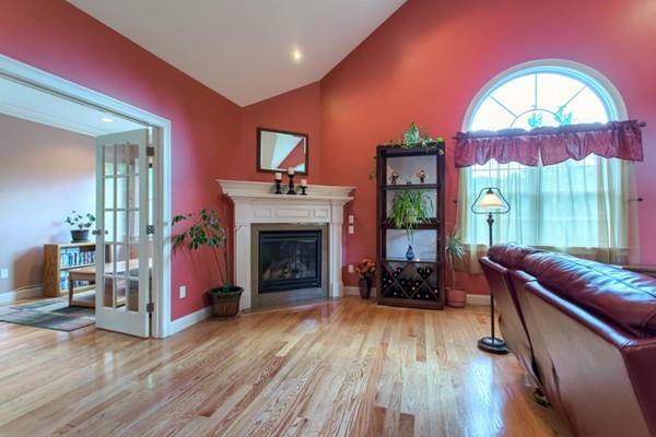 2 Otters Way Sterling, MA 01564 - Photo 6 of 30 a living room with furniture a fireplace and a floor to ceiling window