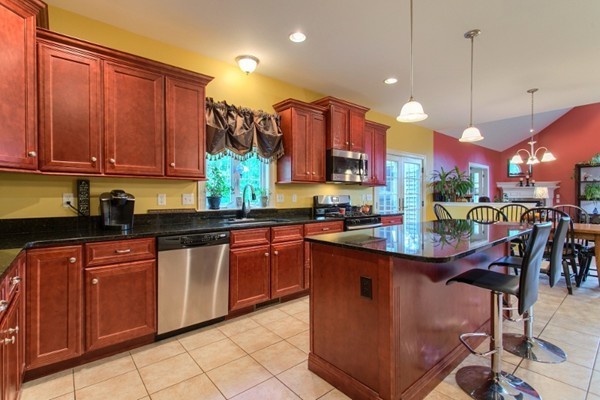 2 Otters Way Sterling, MA 01564 - Photo 8 of 30 a kitchen with stainless steel appliances granite countertop a table chairs and a sink
