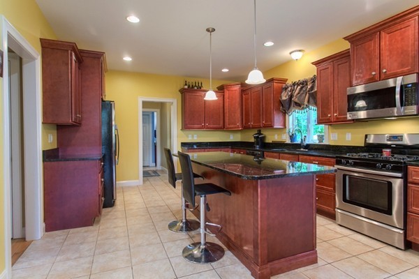 2 Otters Way Sterling, MA 01564 - Photo 9 of 30 a kitchen with stainless steel appliances granite countertop a stove and a refrigerator