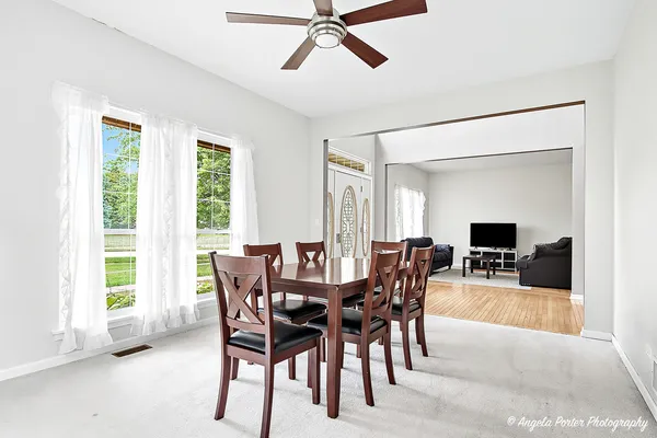 a view of a dining room with furniture window and outside view