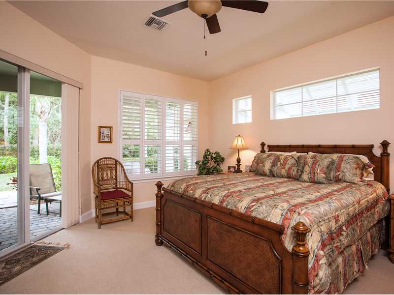 9120 Spring Time Drive Vero Beach, FL 32963 - Photo 6 of 17 a bed sitting in a spacious bedroom next to a window