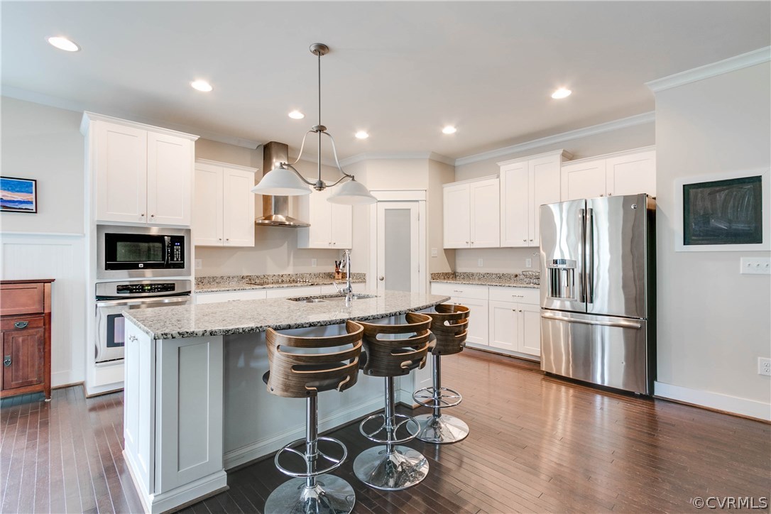 3237 Barkham Drive Midlothian, VA 23112 - Photo 12 of 48 a kitchen with stainless steel appliances granite countertop a refrigerator a stove a sink dishwasher a oven and white cabinets with wooden floor