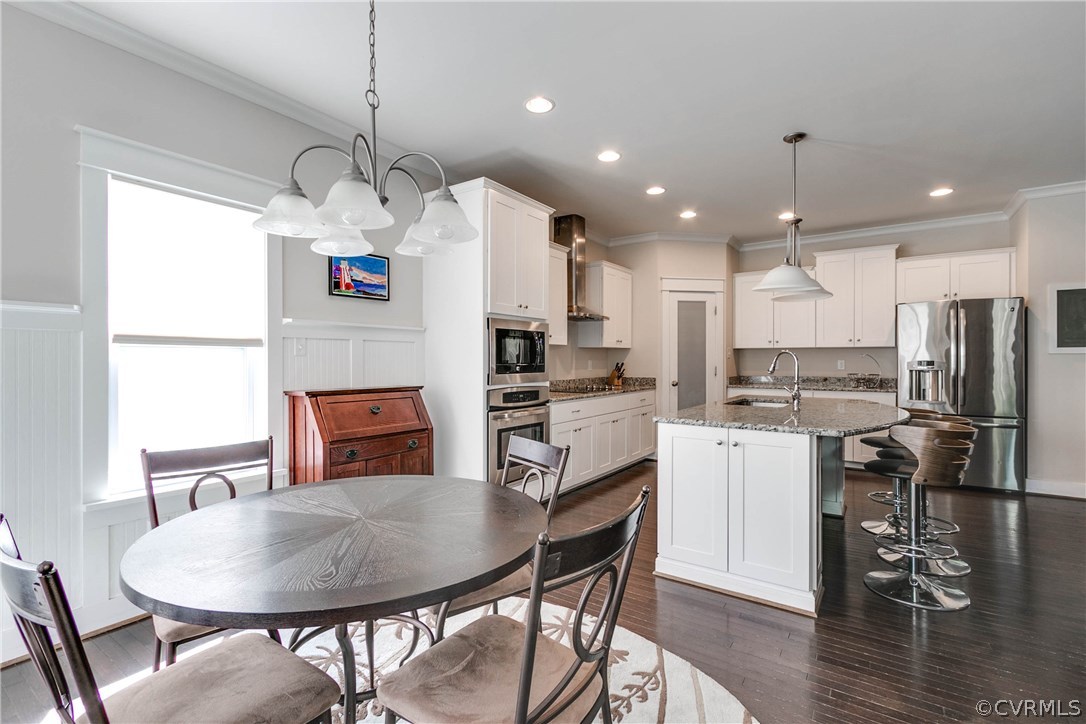 3237 Barkham Drive Midlothian, VA 23112 - Photo 20 of 48 a kitchen with kitchen island a dining table and chairs