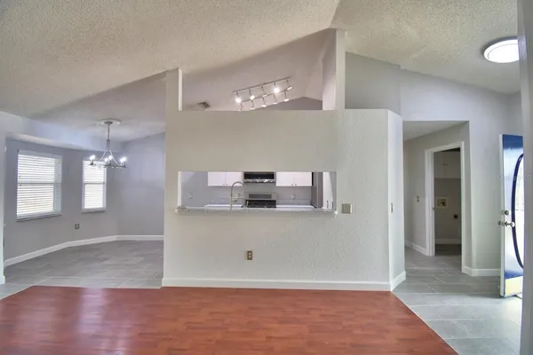a view of a kitchen with a sink and refrigerator