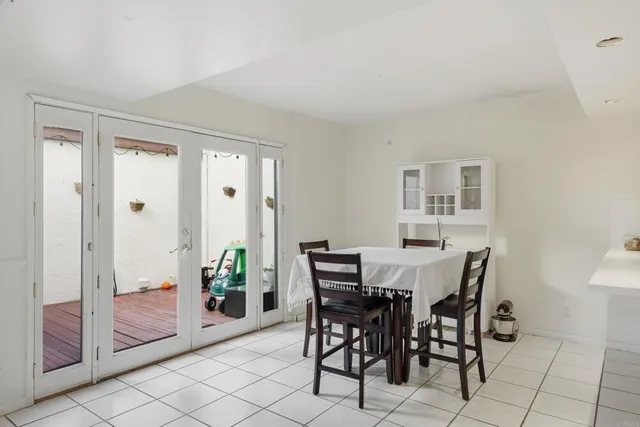 a kitchen with white cabinets and appliances