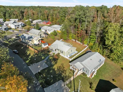 an aerial view of a house with a mountain