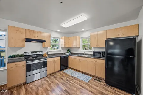 a kitchen with granite countertop stainless steel appliances and wooden cabinets