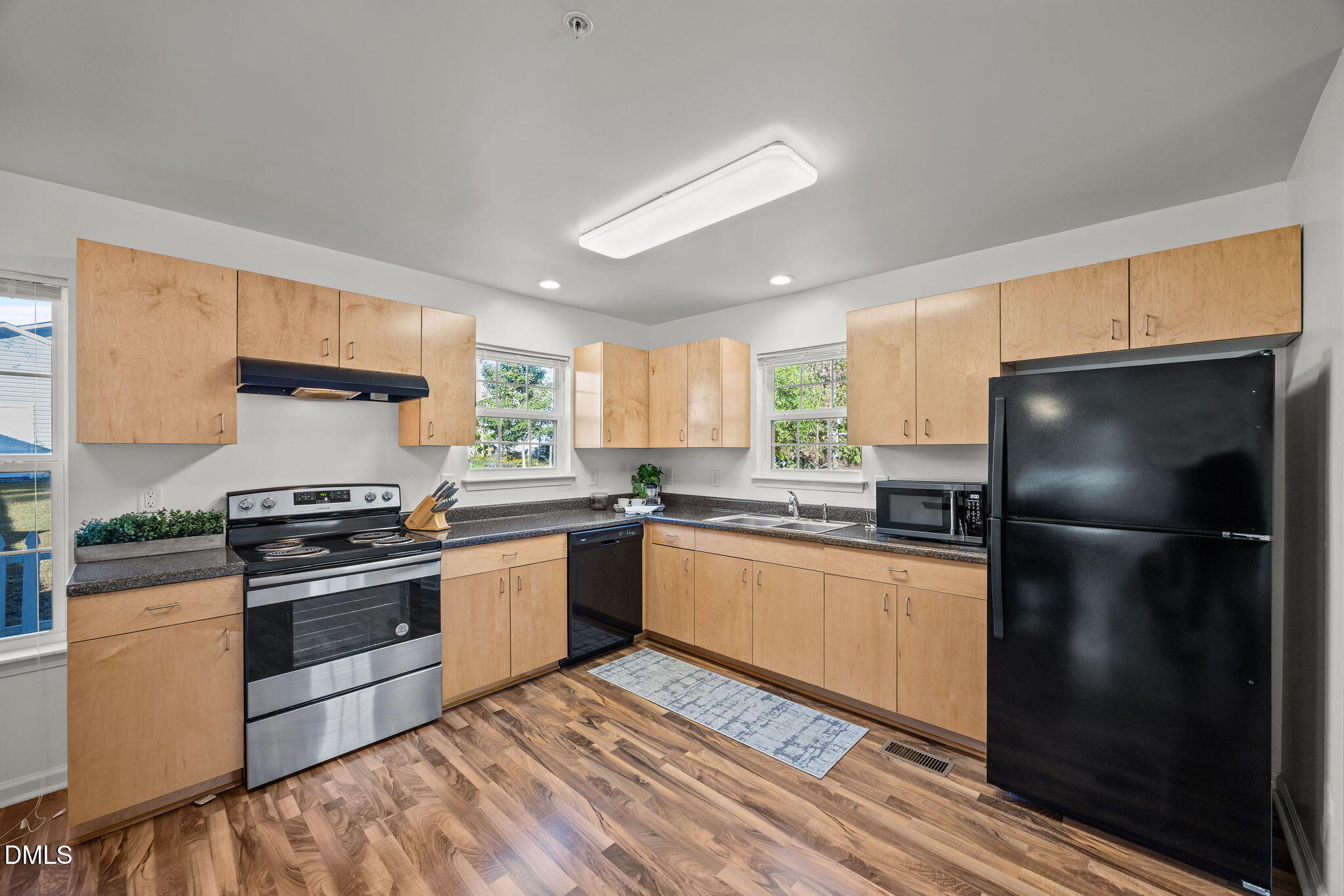 320 School House Road Efland, NC 27243 - Photo 4 of 18 a kitchen with granite countertop stainless steel appliances and wooden cabinets