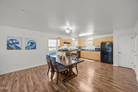 a view of kitchen and dining room with wooden floor