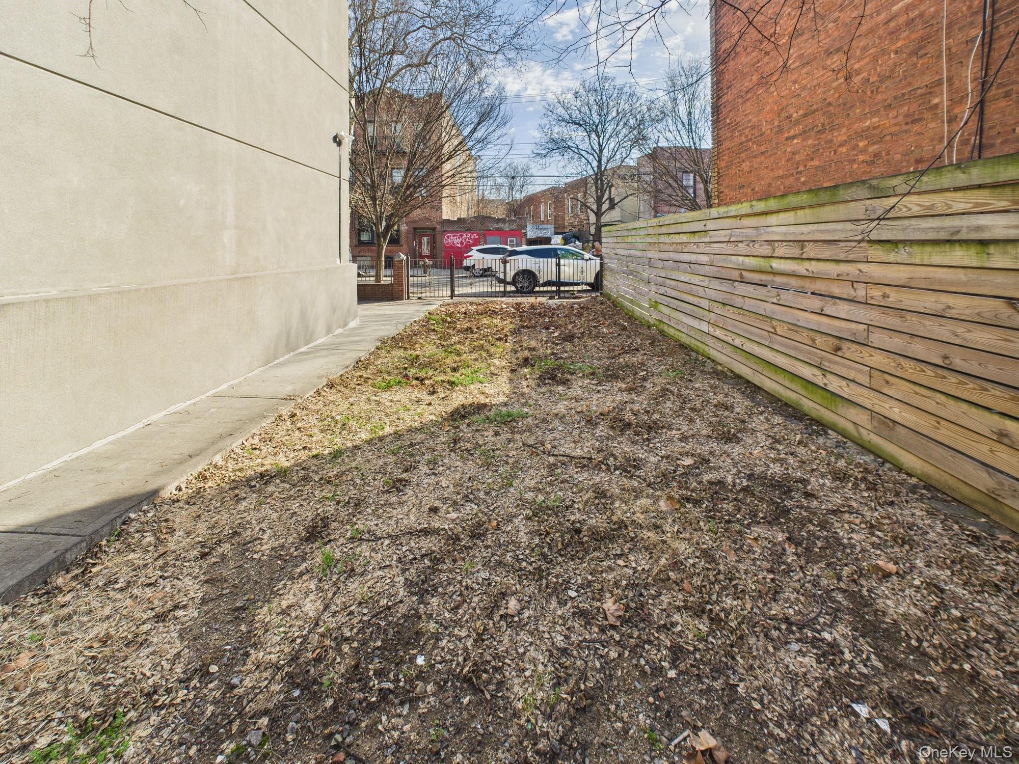 682 Hendrix Street Brooklyn, NY 11207 - Photo 5 of 6 a view of a yard with wooden fence