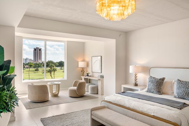 a spacious bedroom with a bed and a large window