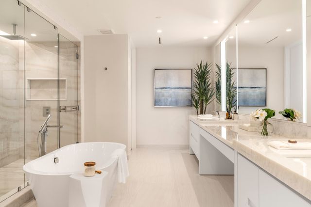 a bathroom with a tub sink and mirror