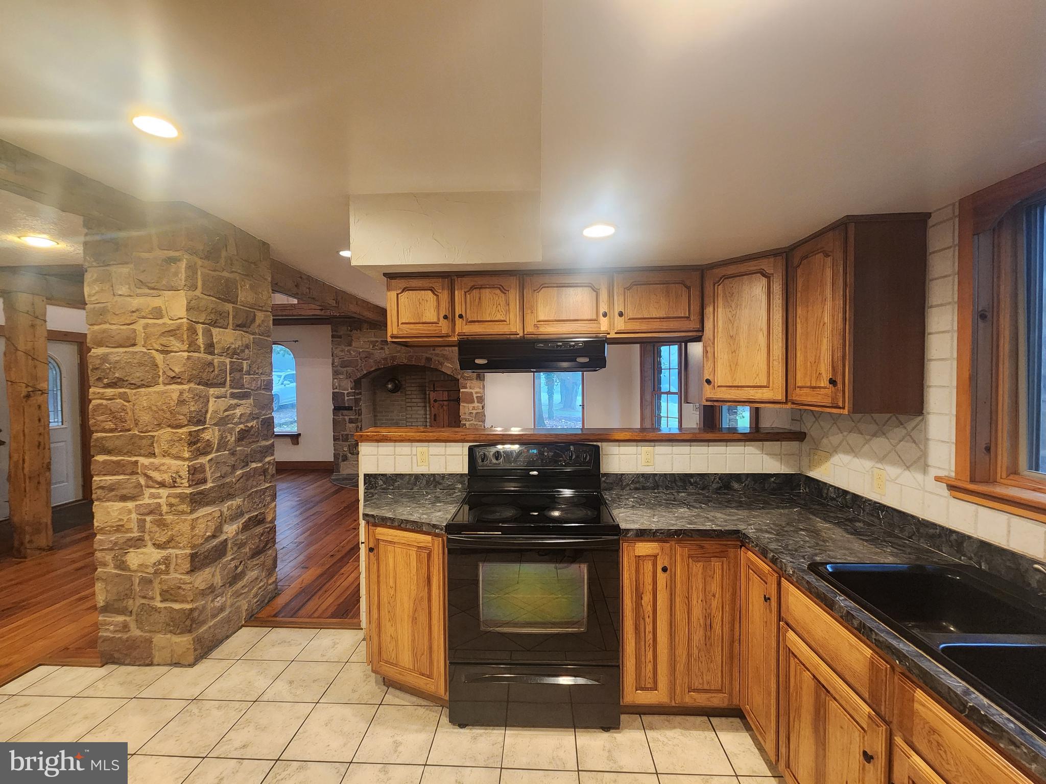 232 Mansion House Road Manheim, PA 17545 - Photo 24 of 107 a kitchen with stainless steel appliances granite countertop a stove a sink and a microwave