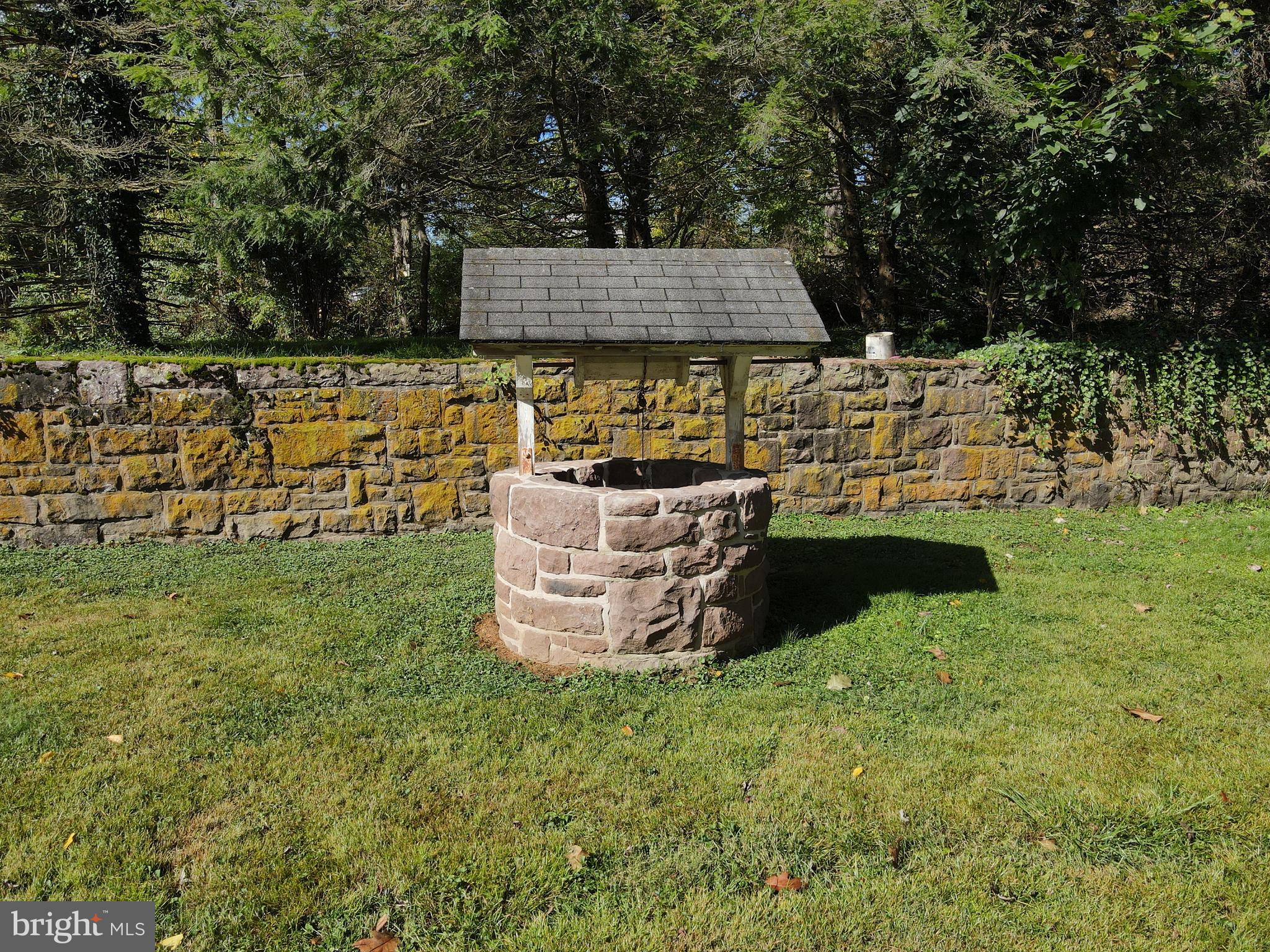 232 Mansion House Road Manheim, PA 17545 - Photo 100 of 107 a wooden bench sitting in the grass near a building