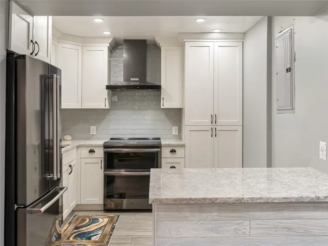 a kitchen with a refrigerator and a stove