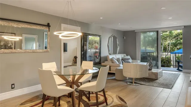 a dining room with furniture and wooden floor