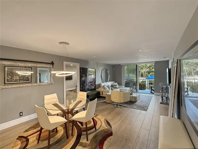 a living room with furniture fireplace and large windows
