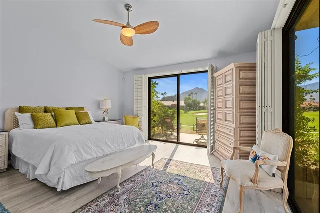 a bed sitting in a bedroom next to a large window