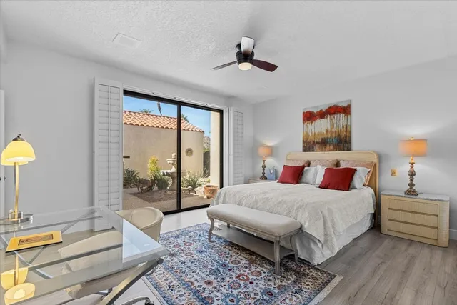 a bedroom with a bed a couch and a window