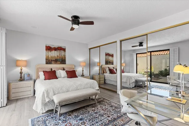 a bedroom with a bed and a flat tv screen on dresser
