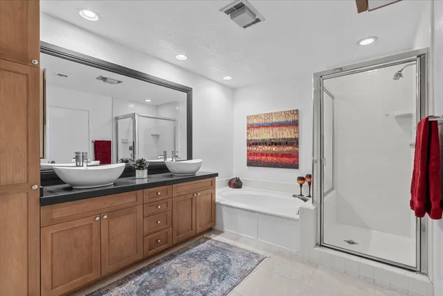 a bedroom with a large bed and a chandelier