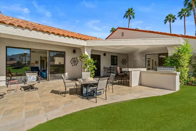 a view of a chairs and table in the patio