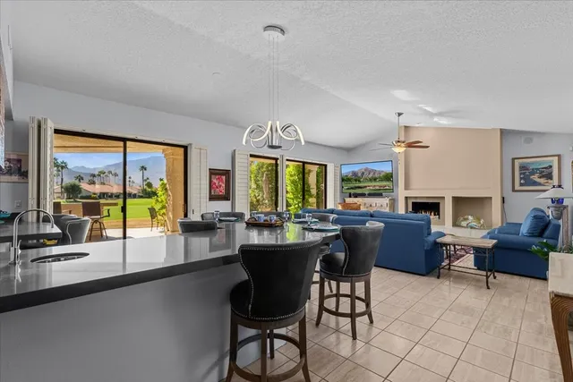 a living room with furniture a large window and a fireplace