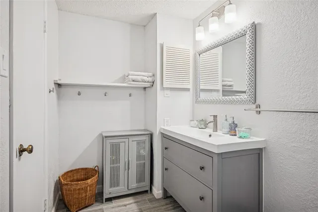 a bathroom with a sink a toilet and mirror