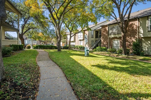 a view of a park with large trees