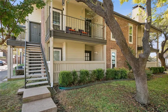 a view of a house with a tree