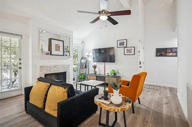 a living room with furniture a fireplace and a flat screen tv