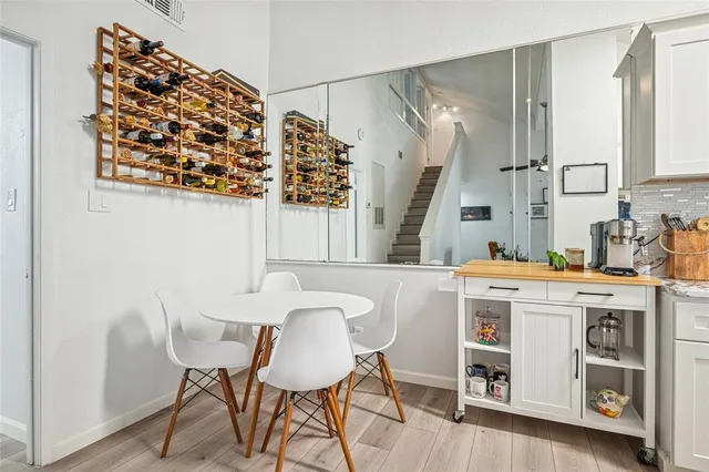 a dining room with a wooden table and chairs