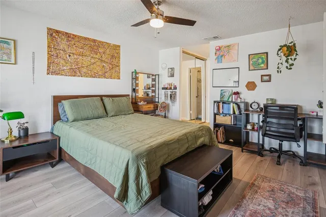 a bed room with a bed and a chair