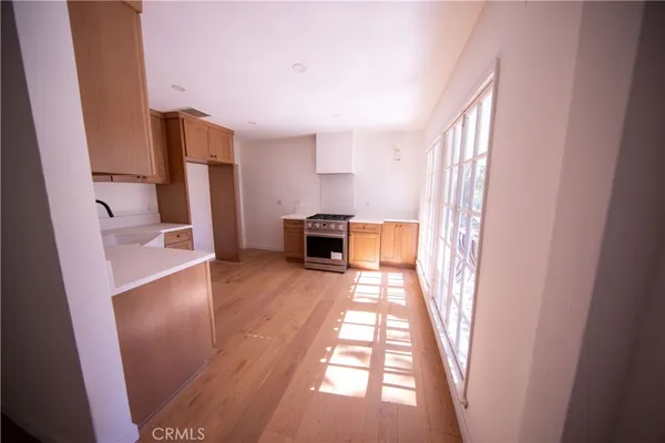 a view of a hallway to a livingroom with furniture and wooden floor
