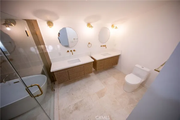 a bathroom with a sink mirror and toilet