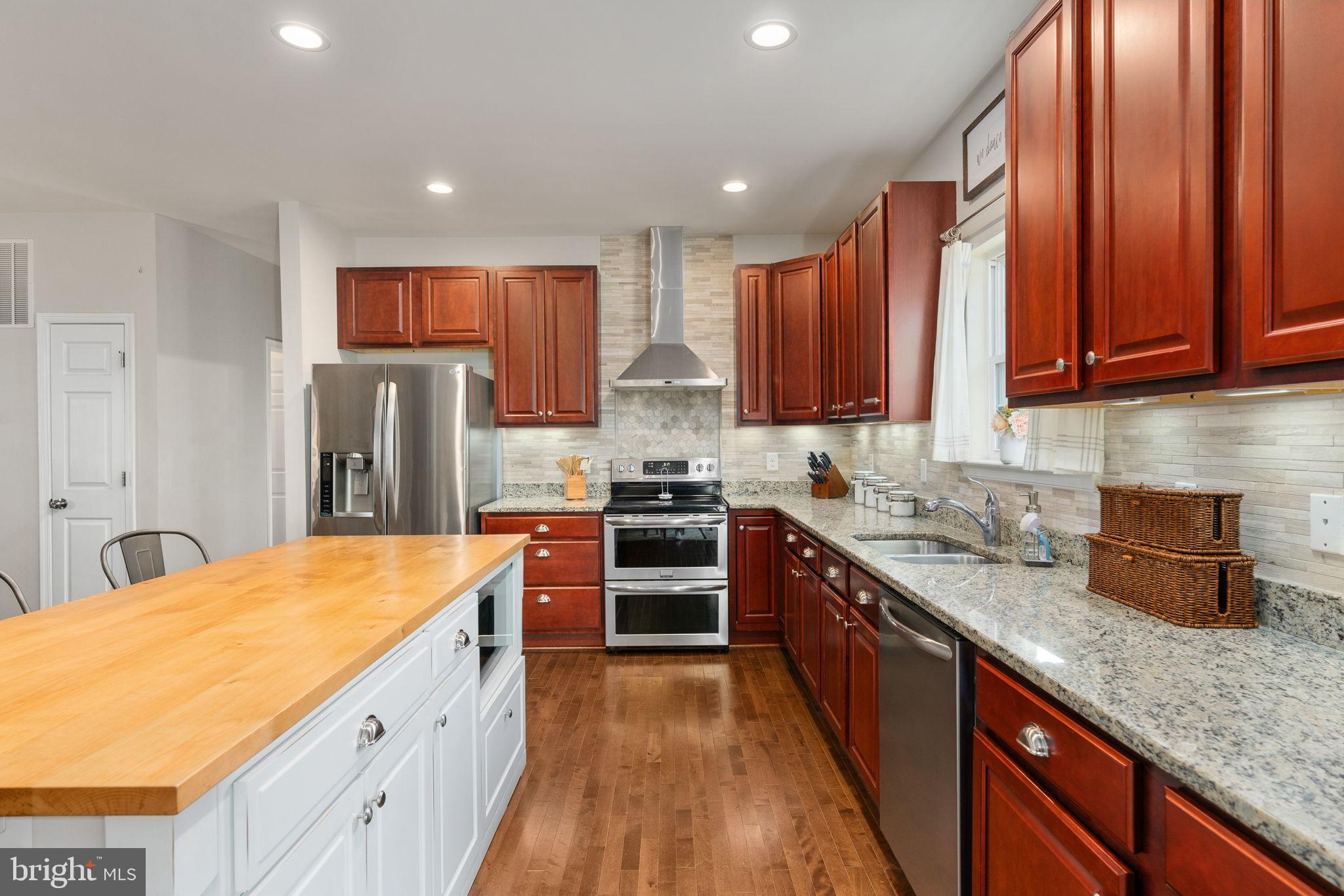 13026 Elk Run Road Bealeton, VA 22712 - Photo 18 of 55 Modern kitchen with rich wood accents.